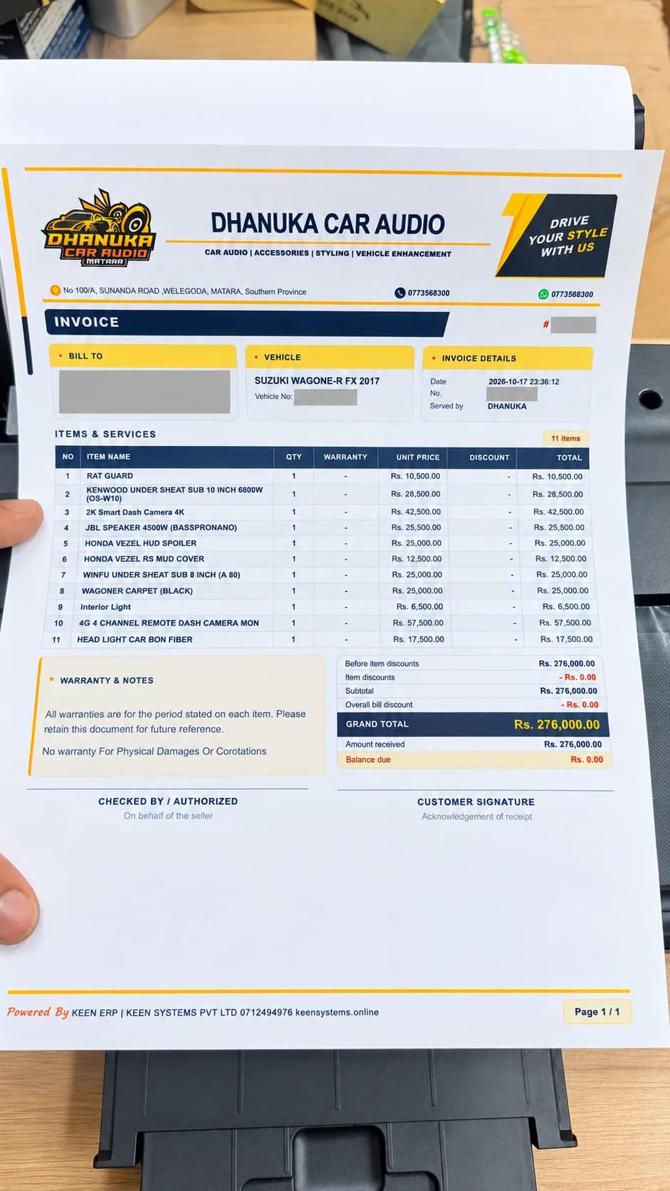 AI-enhanced A4 invoice design above the Dhanuka Car Audio printer