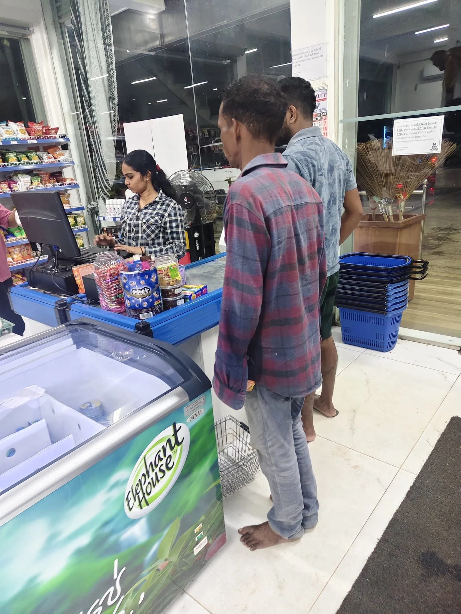 Customers and staff using the Sahan Traders point-of-sale checkout