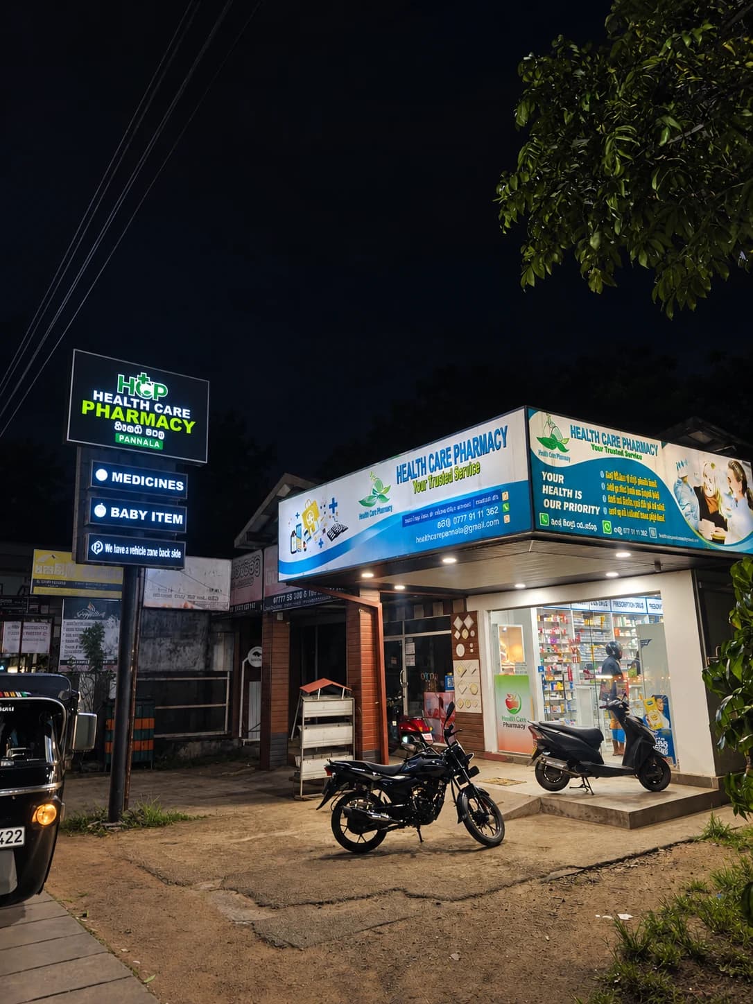 Health Care Pharmacy Pannala storefront illuminated at night