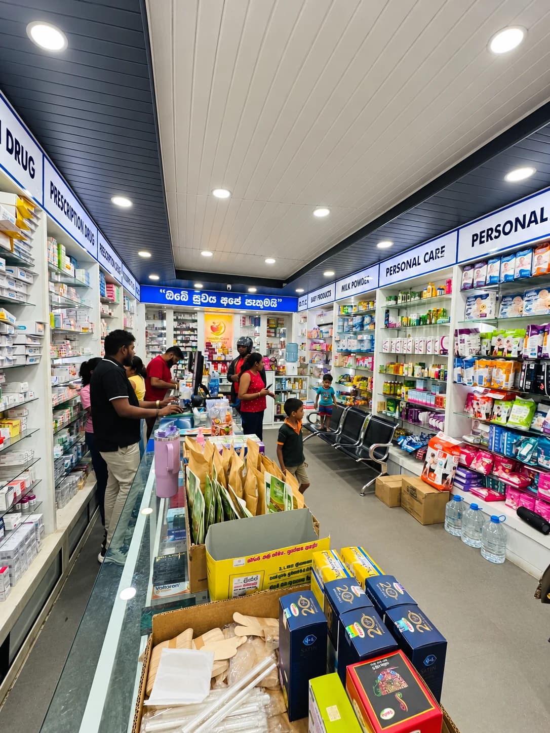 Health Care Pharmacy staff and customers inside the branch